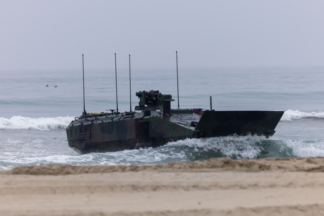 U.S. Marines assigned to Alpha Company, Battalion Landing Team 1/5, 15th Marine Expeditionary Unit, land an Amphibious Combat Vehicle ashore after completing a surf zone transit for an amphibious raid during Realistic Urban Training exercise at Marine Corps Base Camp Pendleton, California, Aug. 25, 2023. RUT is a shore-based, MEU-level exercise that provides an opportunity to train and execute operations as a Marine Air-Ground Task Force in urban environments. (U.S. Marine Corps photo by Lance Cpl. Kahle)