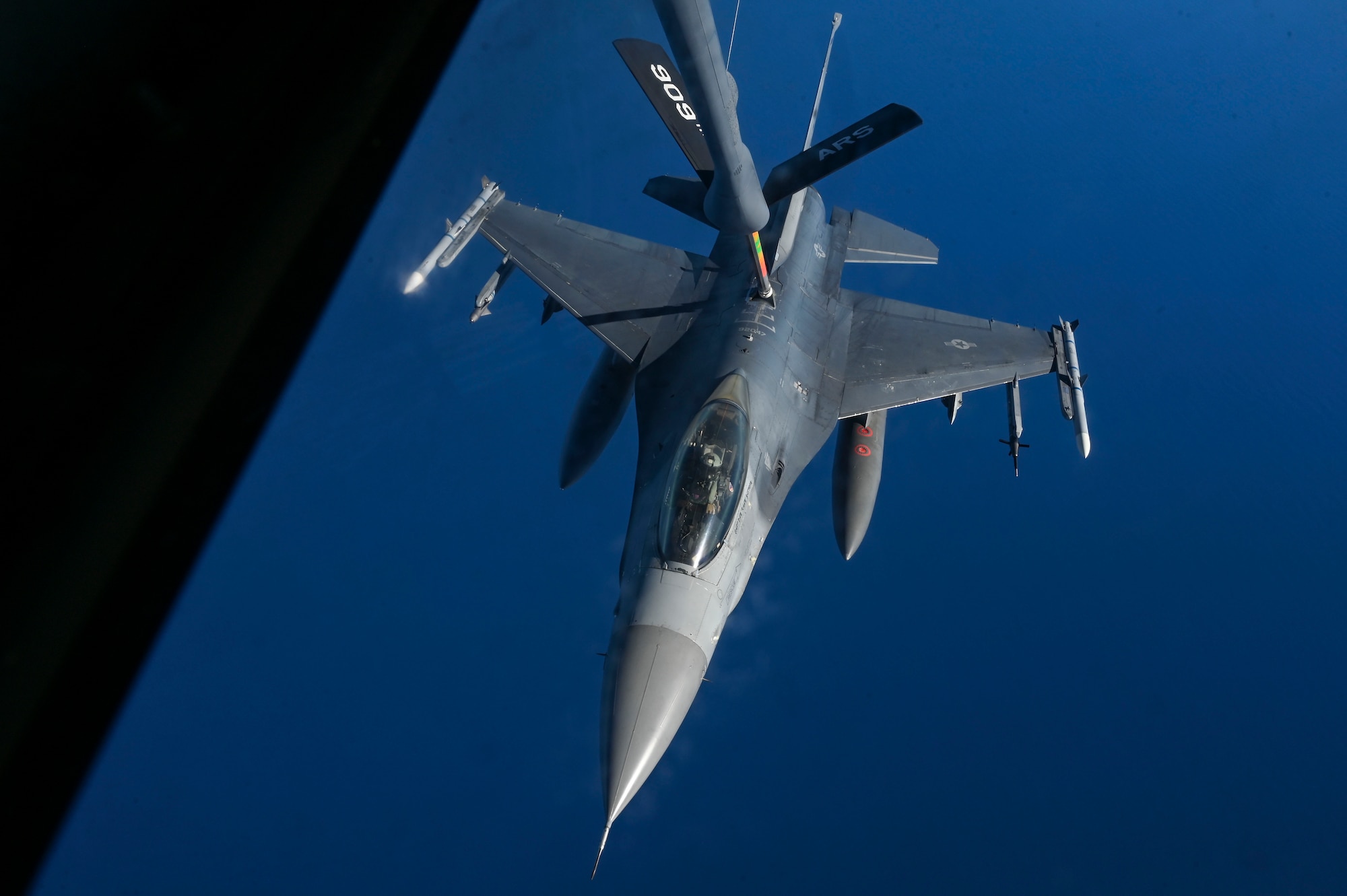 An F-16 fighter jet receives aerial refueling