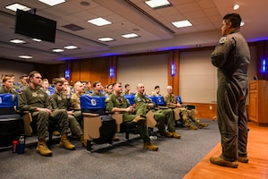 Airmen listen during a briefing