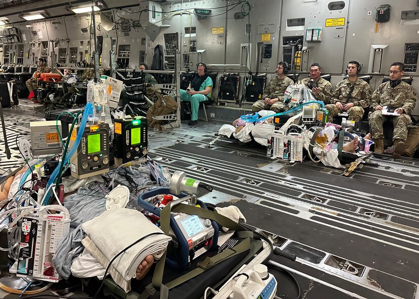 Medics from the 59th Medical Wing’s and Brooke Army Medical Center's Extracorporeal Membrane Oxygenation and Critical Care Air Transport Teams care for two patients from the University Medical Center of El Paso, Texas in a C-17 Globemaster III on the way to BAMC, Joint Base San Antonio-Fort Sam Houston, Texas, Oct. 24, 2023. This is the first air transport of dual-patients on ECMO simultaneously in the Department of Defense’s history. (Courtesy photo by the medical team)