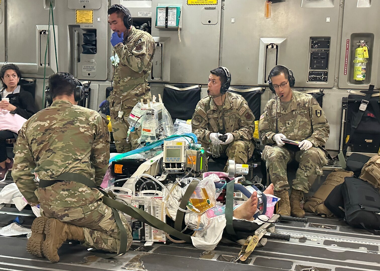 Medics from the 59th Medical Wing’s and Brooke Army Medical Center's Extracorporeal Membrane Oxygenation and Critical Care Air Transport Teams care for one of two patients from the University Medical Center of El Paso, Texas in a C-17 Globemaster III on the way to BAMC, Joint Base San Antonio-Fort Sam Houston, Texas, Oct. 24, 2023. This is the first air transport of dual-patients on ECMO simultaneously in the Department of Defense’s history. (Courtesy photo by the medical team)