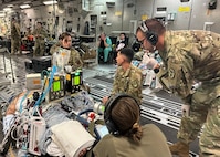 Medics from the 59th Medical Wing’s and Brooke Army Medical Center's Extracorporeal Membrane Oxygenation and Critical Care Air Transport Teams care for one of two patients from the University Medical Center of El Paso, Texas in a C-17 Globemaster III on the way to BAMC, Joint Base San Antonio-Fort Sam Houston, Texas, Oct. 24, 2023. The Department of Defense’s only ECMO team possesses the capability for global transports of all service members. Additionally, the team can transport civilian patients through the Secretarial Designee program or with the Secretary of the Air Force’s approval. (Courtesy photo by the medical team)