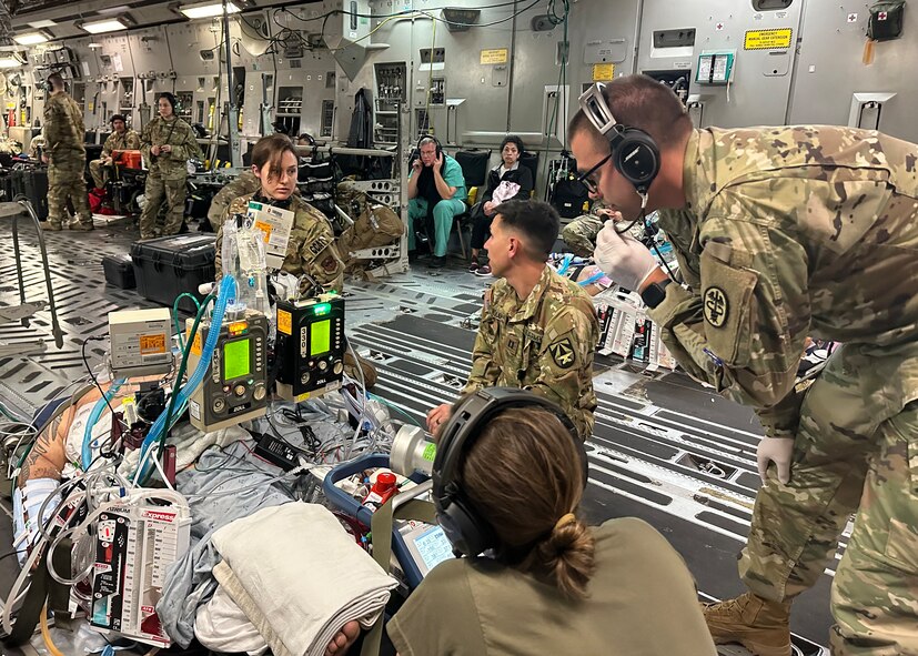 Medics from the 59th Medical Wing’s and Brooke Army Medical Center's Extracorporeal Membrane Oxygenation and Critical Care Air Transport Teams care for one of two patients from the University Medical Center of El Paso, Texas in a C-17 Globemaster III on the way to BAMC, Joint Base San Antonio-Fort Sam Houston, Texas, Oct. 24, 2023. The Department of Defense’s only ECMO team possesses the capability for global transports of all service members. Additionally, the team can transport civilian patients through the Secretarial Designee program or with the Secretary of the Air Force’s approval. (Courtesy photo by the medical team)