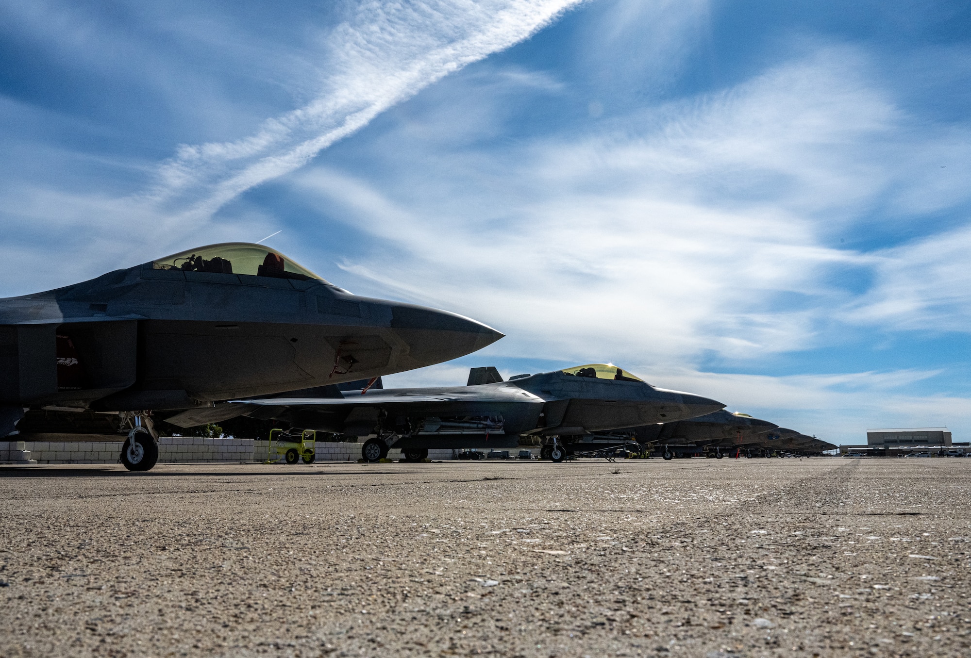 F-22 Raptors deployed under the 525th Expeditionary Fighter Squadron, 3rd Air Expeditionary Wing, Joint Base Elmendorf-Richardson, Alaska, sit on the airfield during Exercise Bamboo Eagle 24-1 at Naval Air Station North Island, California, Jan. 28, 2024.