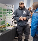 Idrese Manning, waterfront safety advocate, Code 900S, Waterfront Safety, outlines the "1000 Steps to Mentoring Program" for an employee during Code 350’s first-ever Integrated Project Team Development Step III knowledge share fair at the Kitsap Conference Center in downtown Bremerton, Washington, Jan 13, 2023. (U.S Navy photo by Wendy Hallmark)
