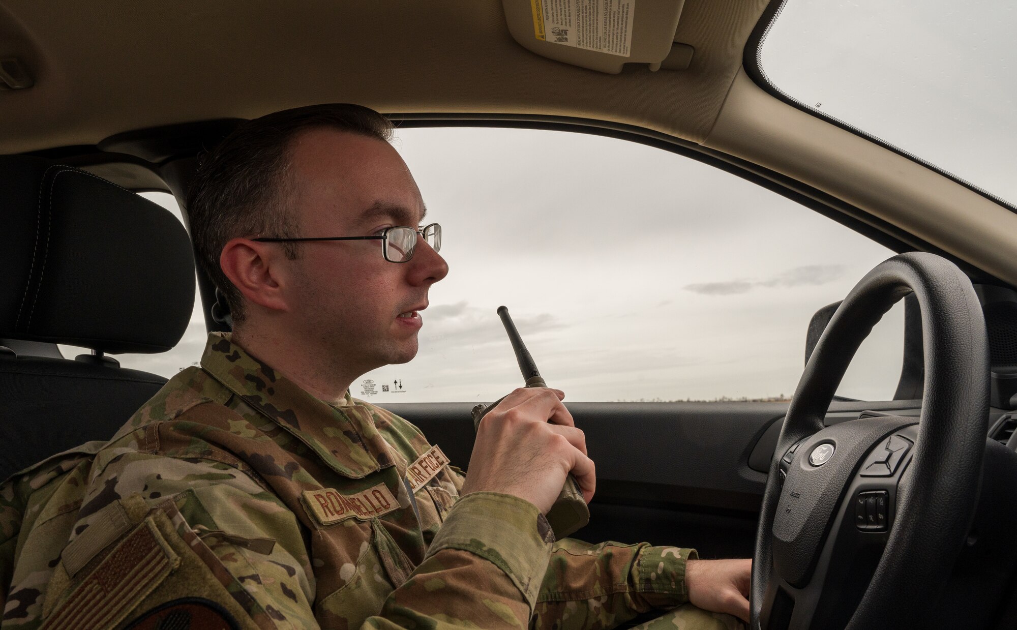An airman uses a radio