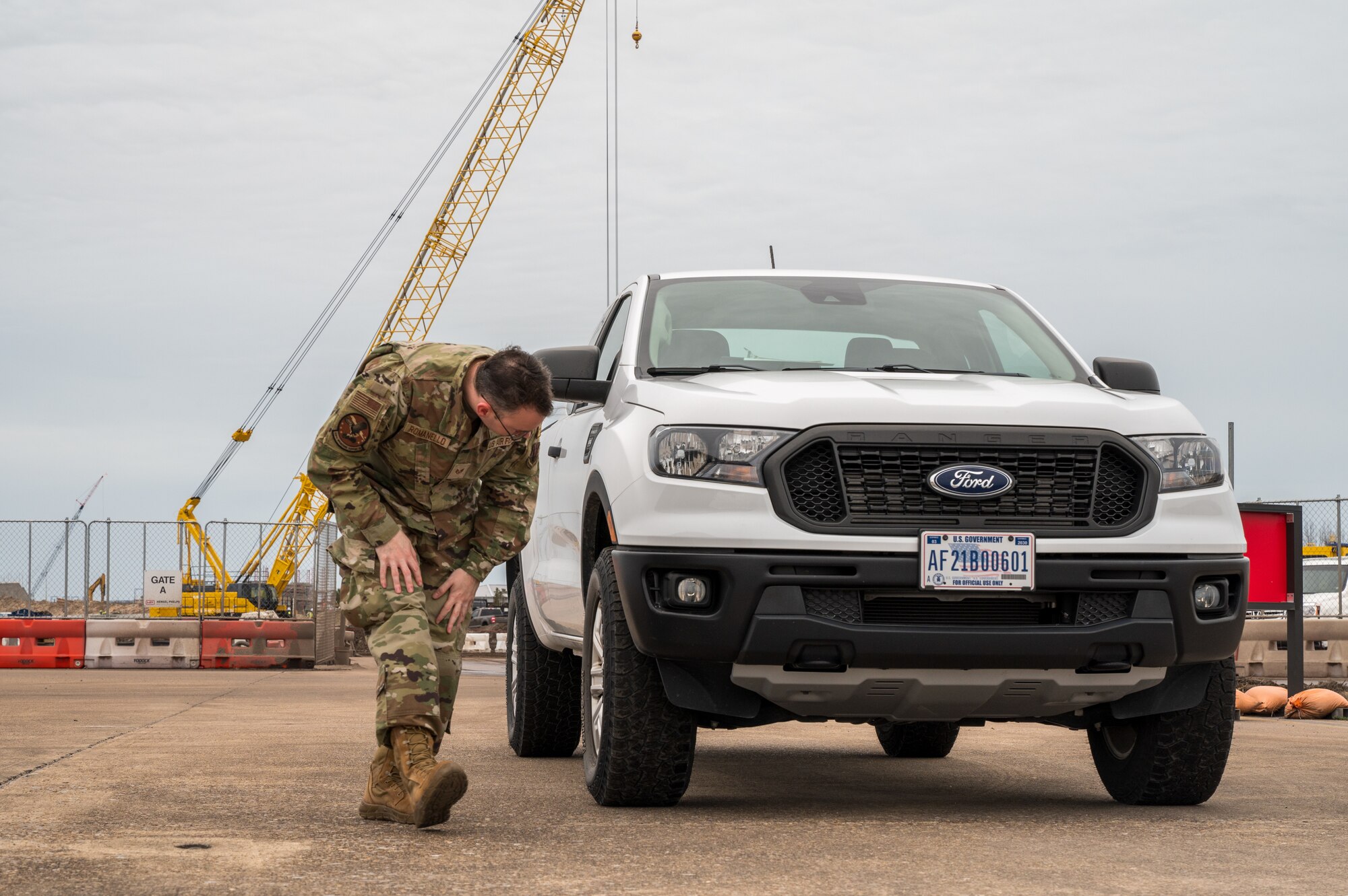 An airmen preforms a vehicle inspection