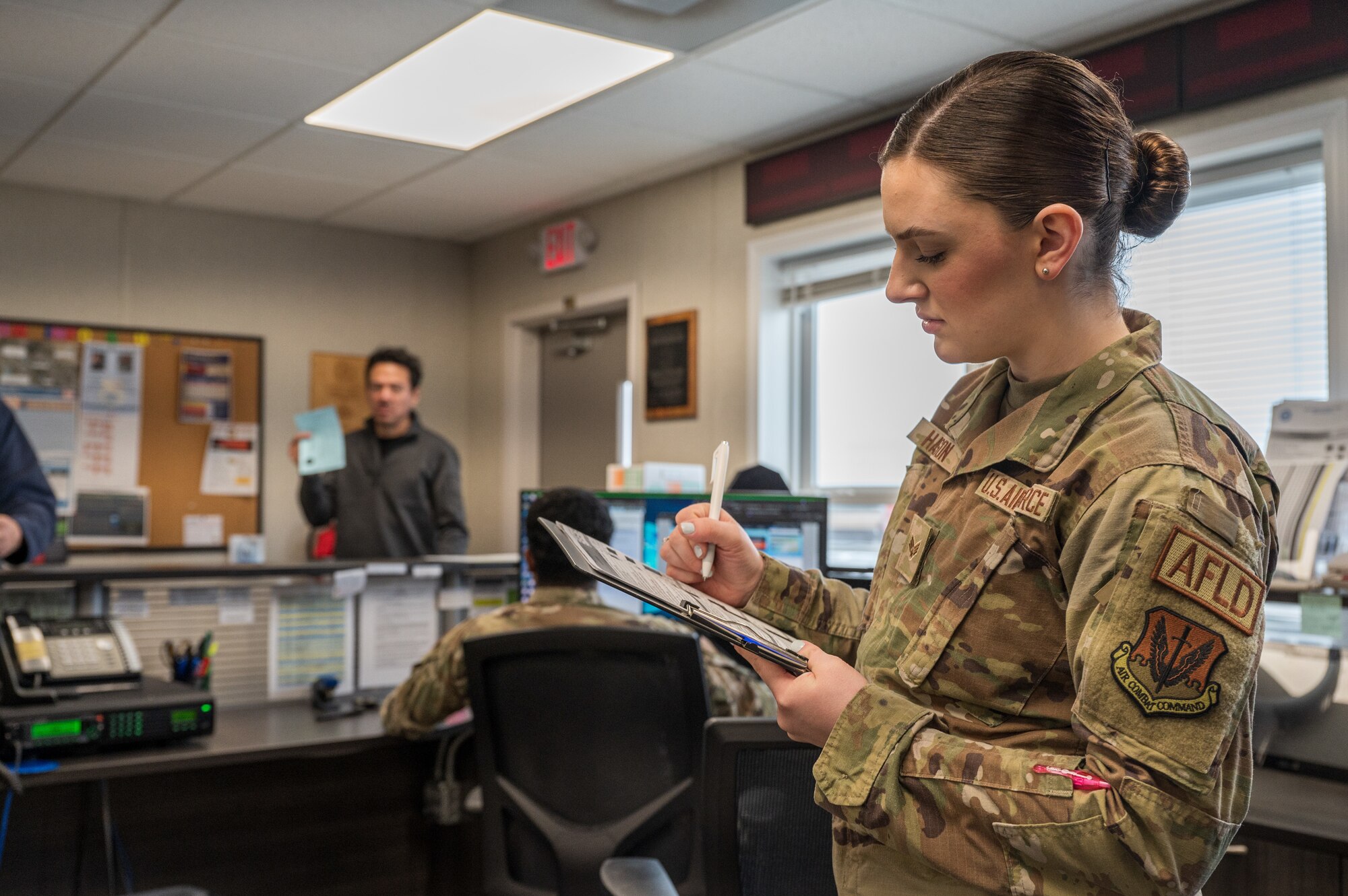 An airmen fills out a checklist