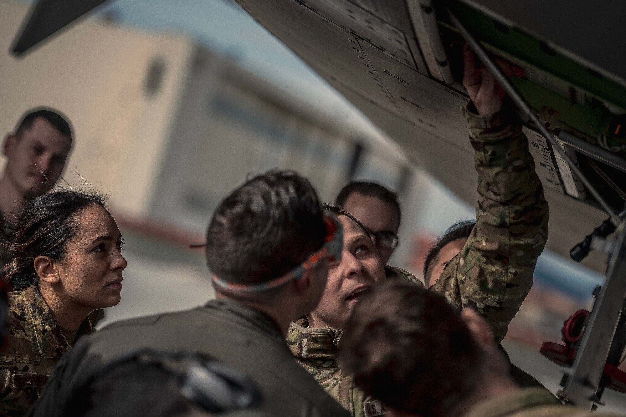 U.S. Air Force Staff Sgt. Nicole Stephenson, 108th Wing boom operator, looks on with members of the 2nd Air Refueling Squadron as Senior Airman Seth Ambos, 605th Aircraft Maintenance Squadron maintainer, provides training on the KC-46A Pegasus during Exercise Bamboo Eagle 24-1 at Travis Air Force Base, Calif., Jan. 27, 2024. Bamboo Eagle 24-1 is an operational implementation of multi-domain combat readiness training. (U.S. Air Force photo by Staff Sgt. Austin Knox)