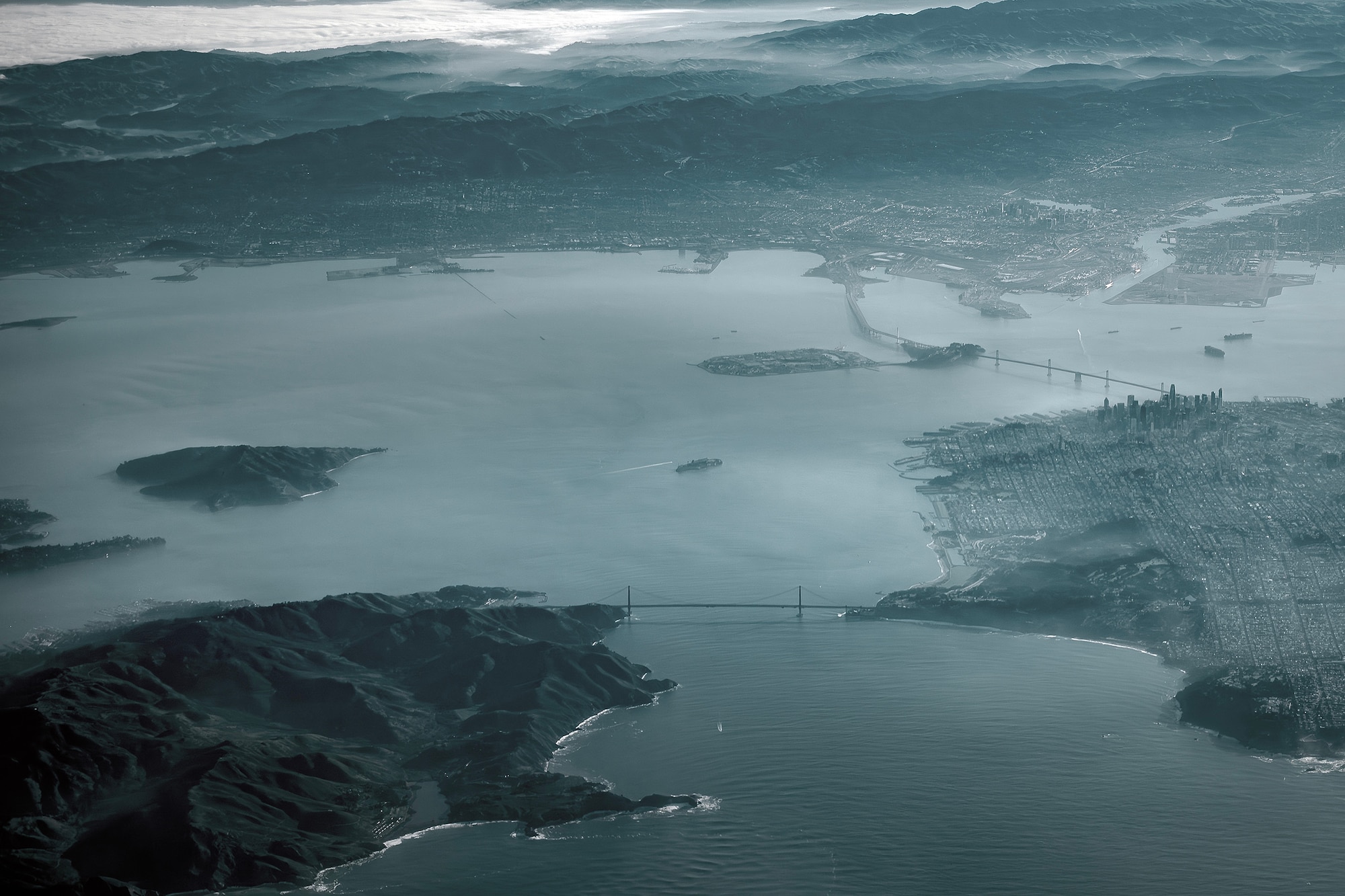 U.S. Air Force Airmen fly over the San Francisco Bay while aboard a KC-46A Pegasus during the Bamboo Eagle 24-1 exercise at Travis Air Force Base, Calif., Jan. 29, 2024. . Bamboo Eagle 24-1 is an operational implementation of multi-domain combat readiness training. (U.S. Air Force photo by Staff Sgt. Austin Knox)