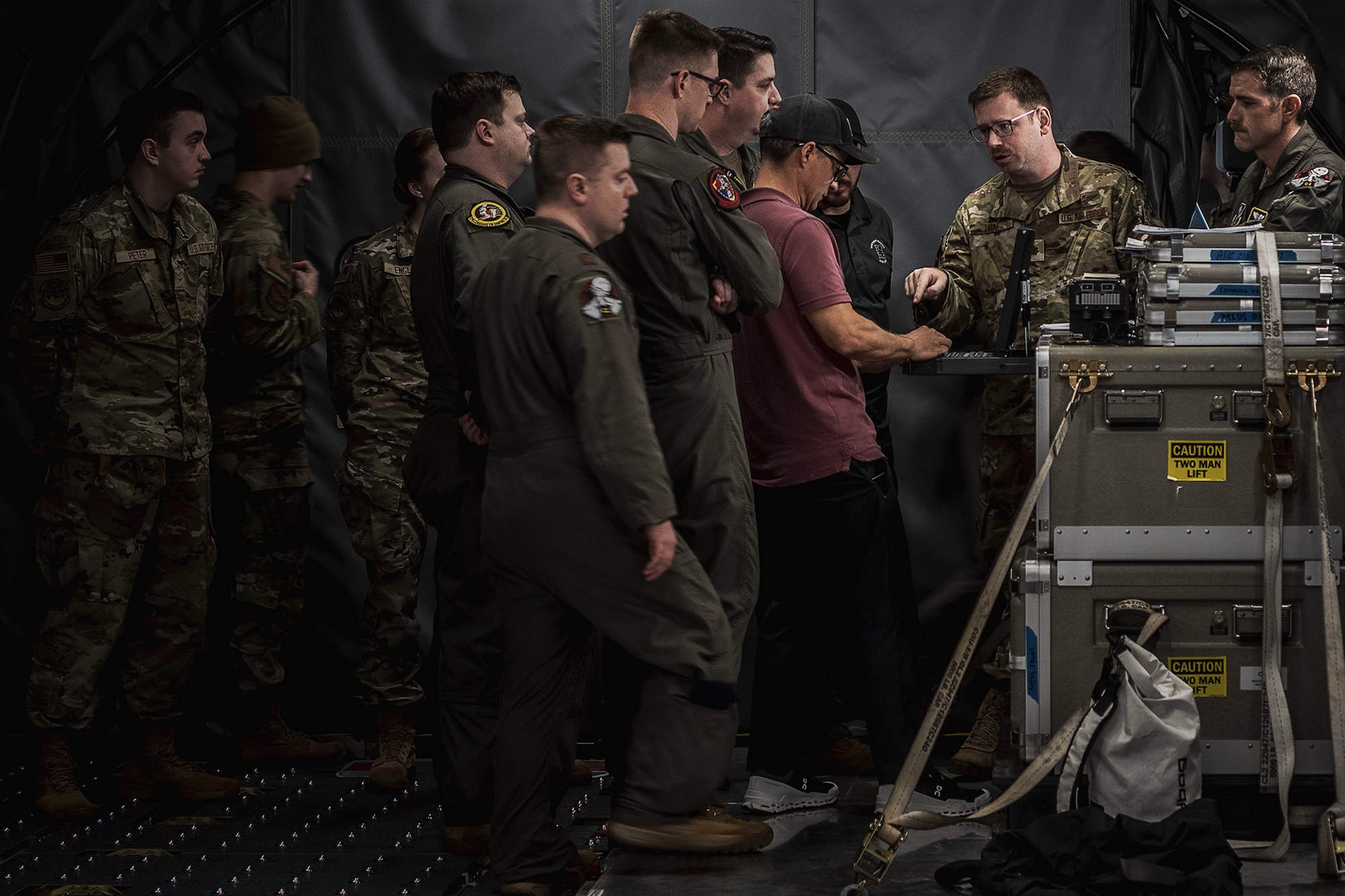 Participants of Bamboo Eagle 24-1 conduct Roll-on Beyond Line-of-Sight Enhancement training aboard a KC-46A Pegasus from the 2nd Air Refueling Squadron assigned to the 305th Air Mobility Wing, Joint Base McGuire-Dix-Lakehurst, N.J., at Travis Air Force Base, Calif., Jan. 27, 2024. A ROBE is a self-contained communications suite that advances access to user gateways more efficiently to further combat effectiveness. (U.S. Air Force photo by Staff Sgt. Austin Knox)