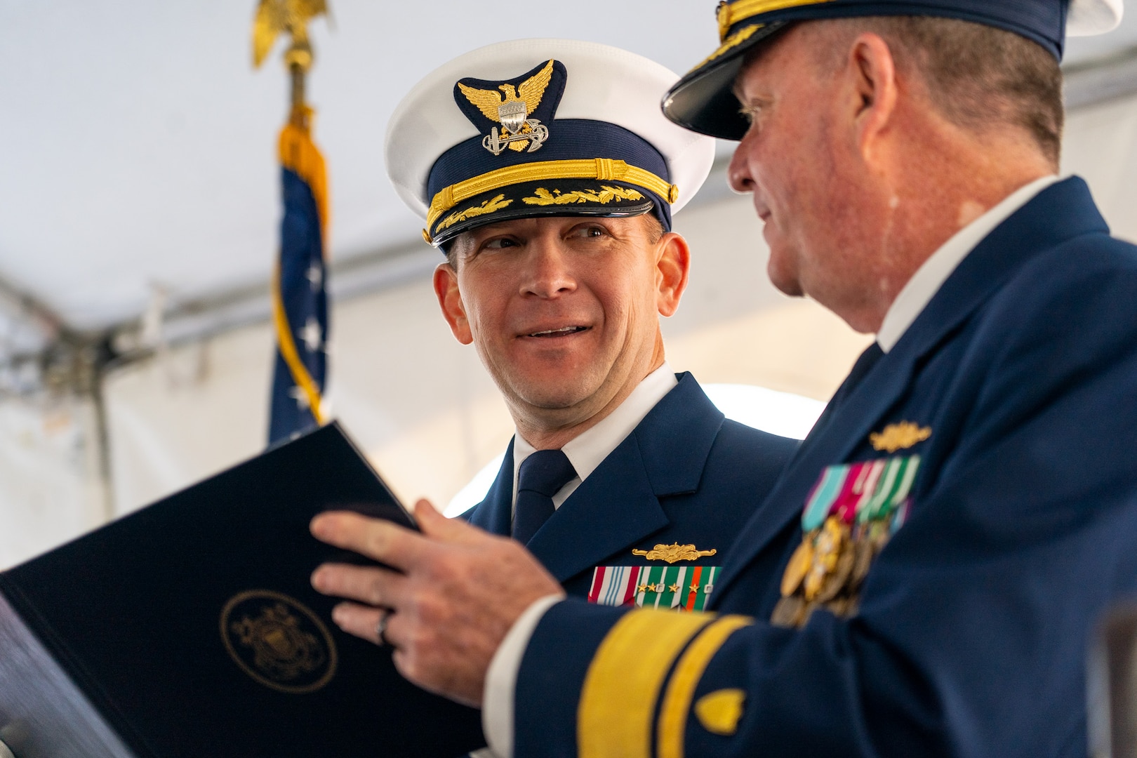Rear Adm. Brendan McPherson, the deputy commander of Coast Guard Pacific Area, presents Cmdr. Brock S. Eckel, the commanding officer of USCGC Steadfast (WMEC 623), the Meritorious Service Medal during a decommissioning ceremony for Steadfast in Astoria, Oregon, Feb. 1, 2024. Steadfast was commissioned in 1968 and spent nearly 30 years in Astoria. (U.S. Coast Guard photo by Petty Officer 1st Class Travis Magee)
