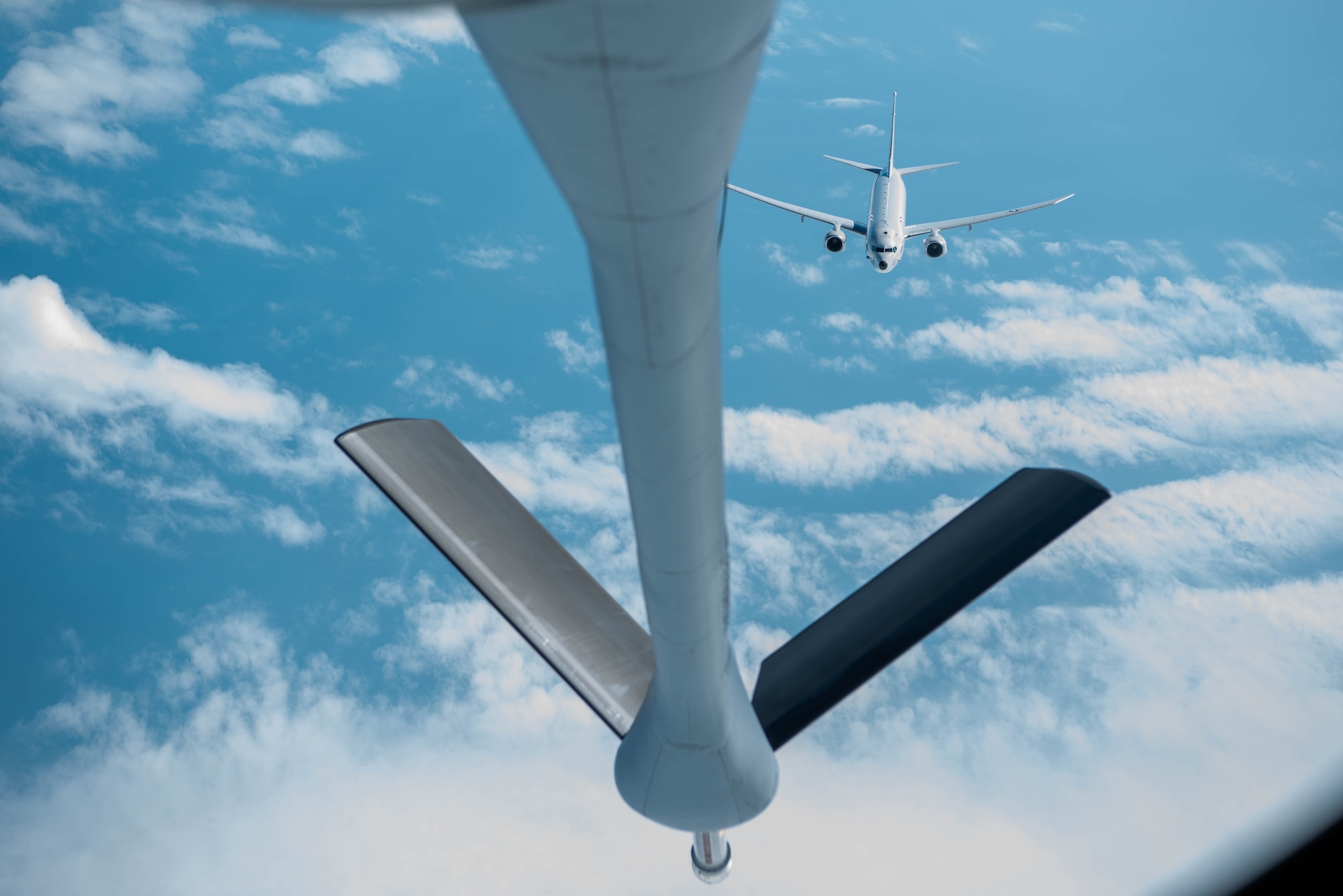 Navy plane flies to a Air Force refueling plane