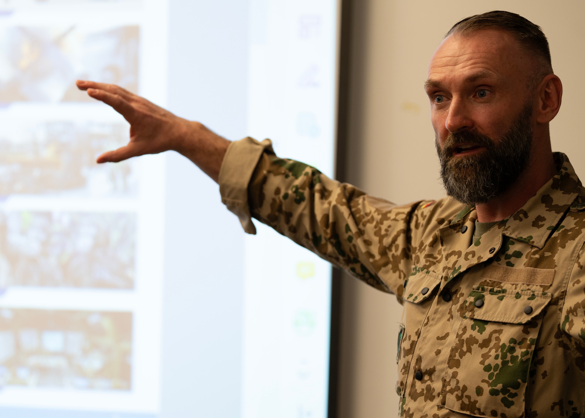 German Air Force Lt. Col. Artur Zielinski, DEU Air Forces Command, participates in a Security Forces Key Leader Engagement by giving a brief overview of the practices, procedures, and structure of military security in Germany at Andersen Air Force Base, Guam, Jan. 30, 2024. The purpose of the KLE meeting is to enhance interpersonal relationships among attendees, and provide networking opportunities for multilateral partnerships and allies. (U.S. Air Force photo by Airman 1st Class Audree Campbell)
