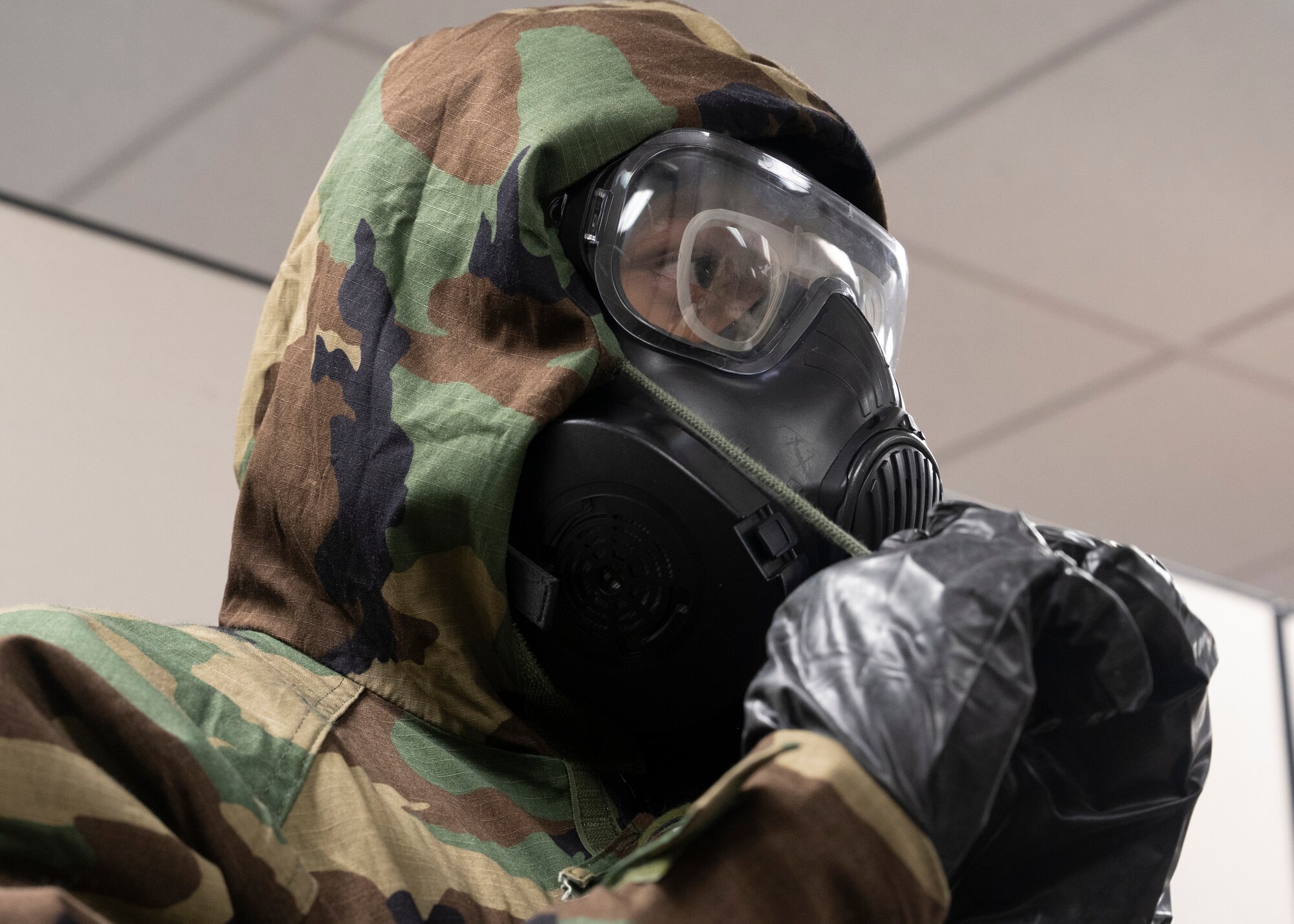 A U.S. Airmen wears protective gear to prepare for a training exercise.