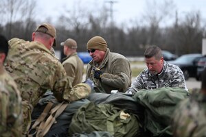 Chief Master Sgt. Sean Storms, 87th Aerial Port Squadron aerial port manager, works with Airmen and base contractors to break down a baggage pallet at Wright-Patterson Air Force Base, Ohio, Jan. 4, 2024. The bags belong to Airmen who returned to the 445th Airlift Wing following a deployment. (U.S. Air Force photo/Master Sgt. Patrick O’Reilly)