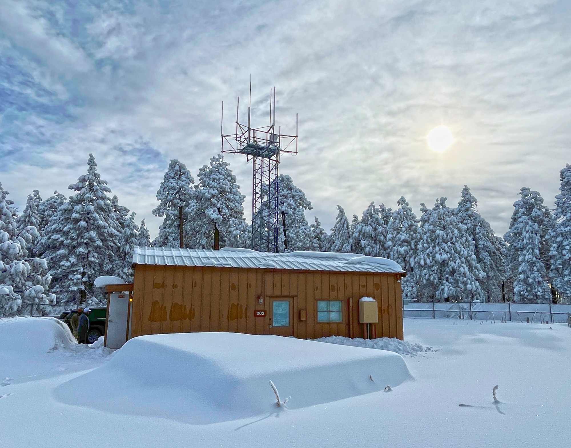 Exterior picture of Mt. Lemmon building and and radio tower covered in snow.