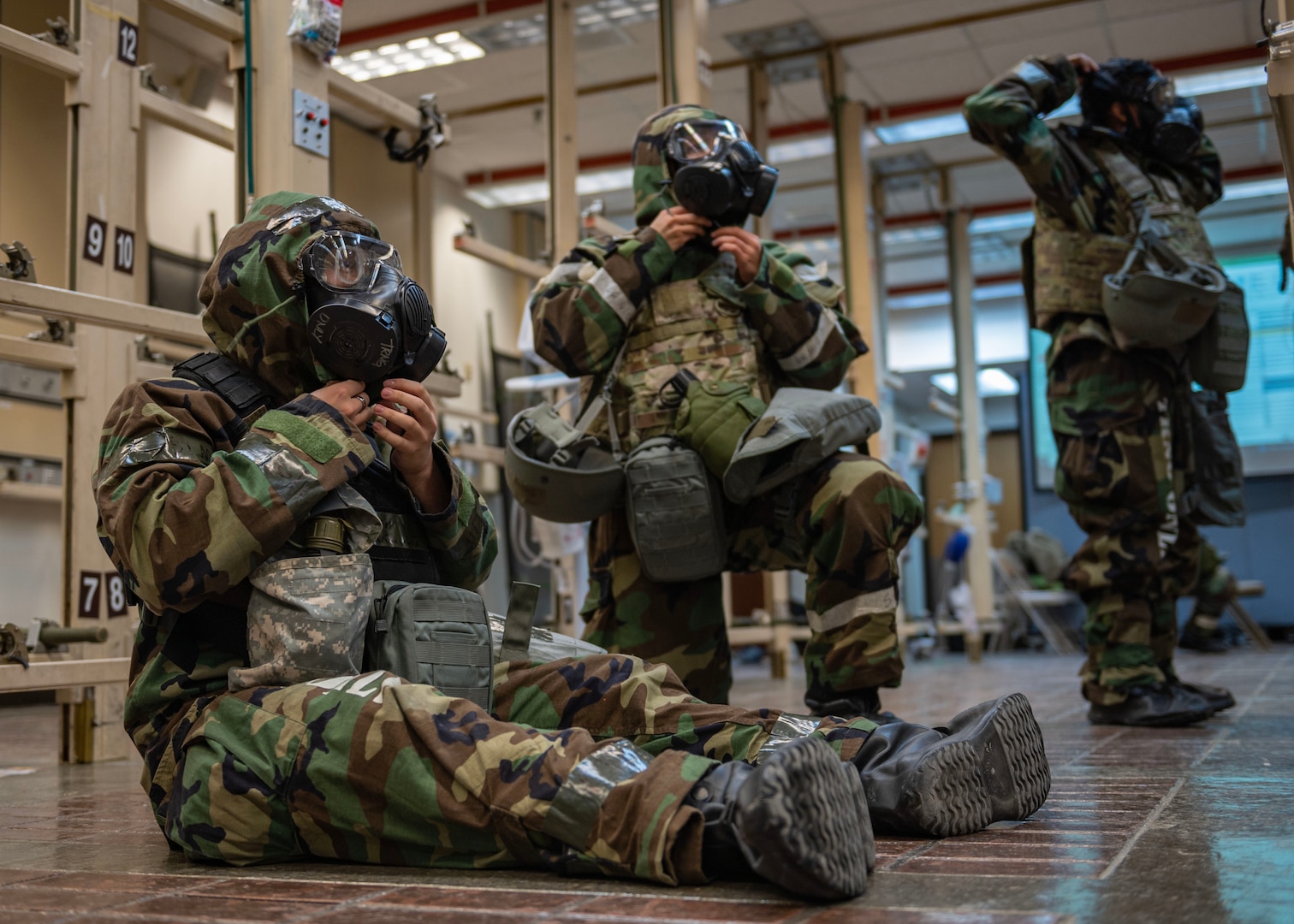 U.S. Air Force members assigned to the 51st Medical Group put on Mission Oriented Protective Posture level four gear during Beverly Midnight 24-1 at Osan Air Base, Republic of Korea, Feb. 1, 2024. MOPP 4 should be established when a unit will be operating within an area of contamination, or if there is an imminent threat of attack. BM24-1 is a routine training event that tests the military capabilities across the peninsula, allowing combined and joint training at both the operational and tactical levels. (U.S. Air Force photo by Staff Sgt. Aubree Owens)
