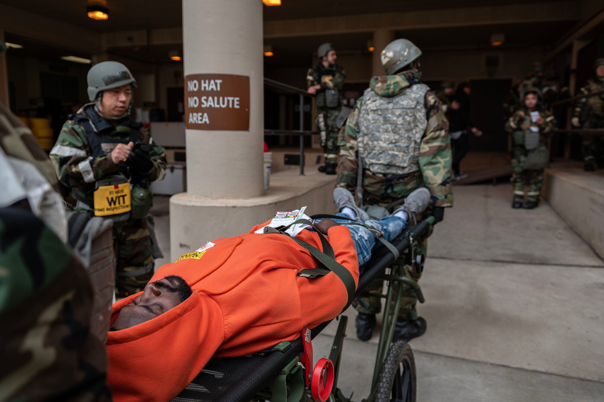 U.S. Air Force Airmen assigned to the 51st Medical Group move a simulated patient on a gurney in a mass casualty training event during Beverly Midnight 24-1 at Osan Air Base, Republic of Korea, Feb. 1, 2024. Simulated patients were transported inside after being prioritized in distinctive categories to allow emergency room personnel to simulate treating the most critically injured first upon their arrival. BM24-1 is a routine training event that tests the military capabilities across the peninsula, allowing combined and joint training at both the operational and tactical levels. (U.S. Air Force photo by Staff Sgt. Aubree Owens)