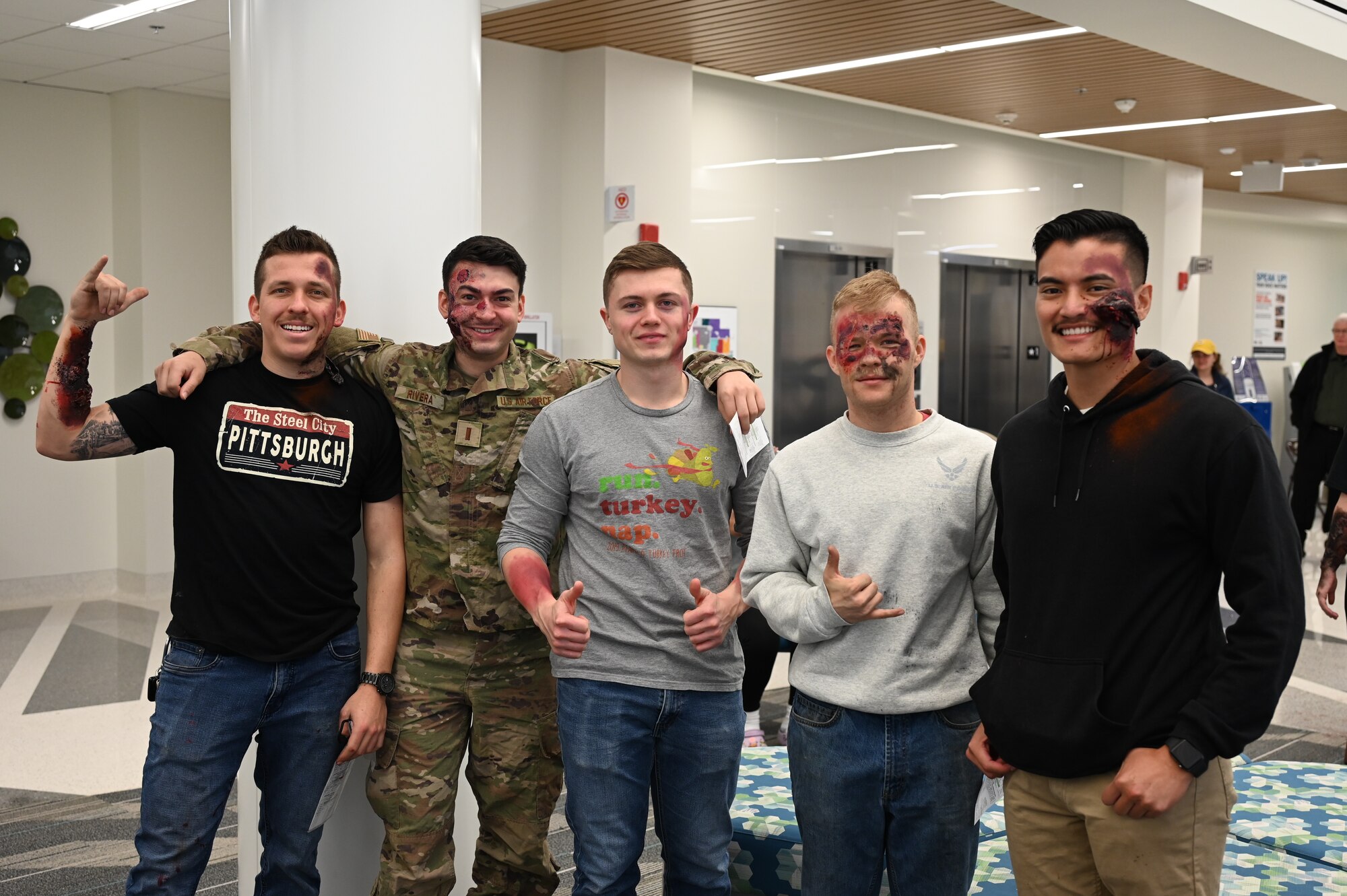 A group of five men from the 80th Flying Training Wing pose as they show off their moulage.
