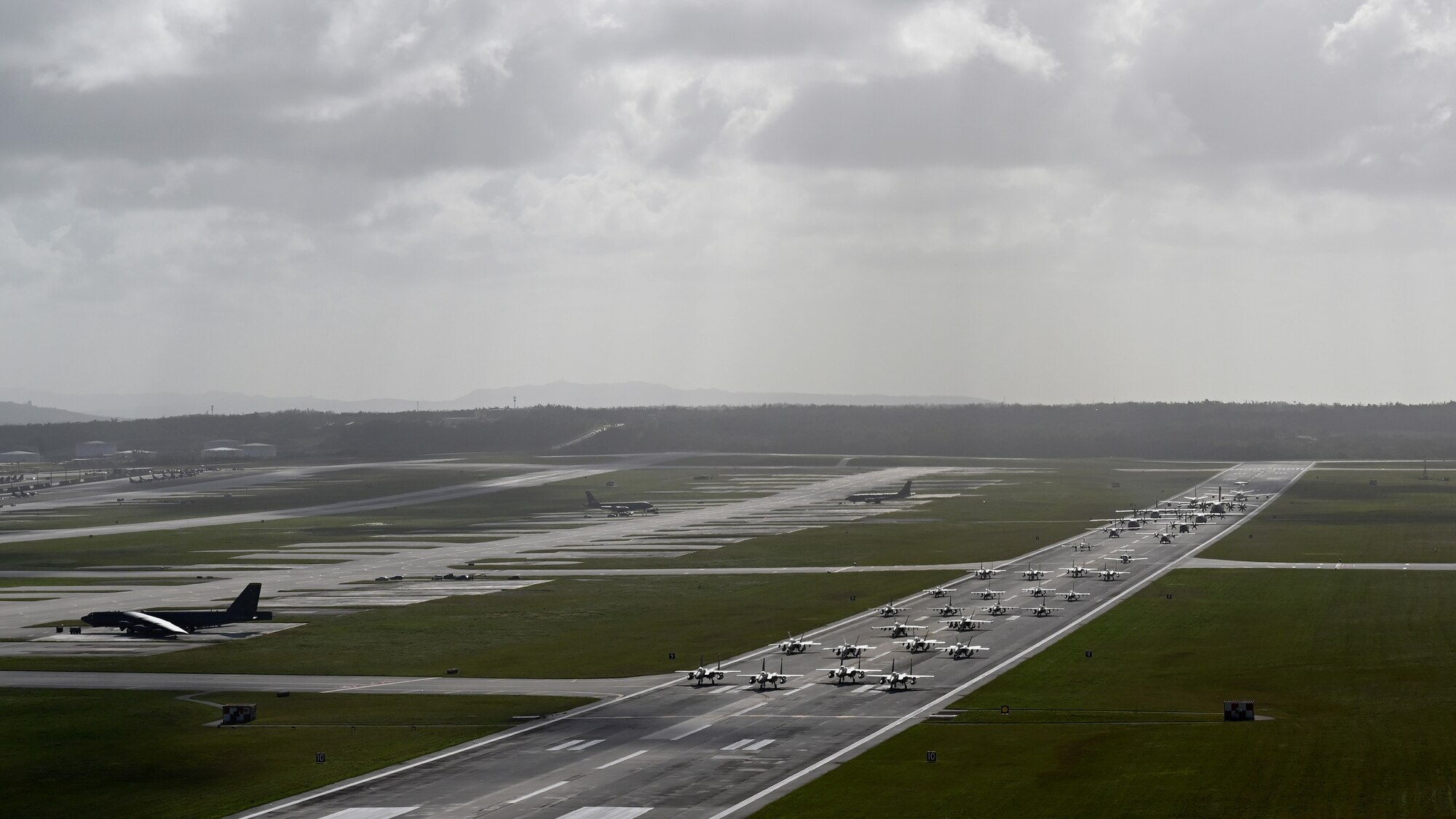 Photo of a multinational elephant walk at Andersen Air Force Base