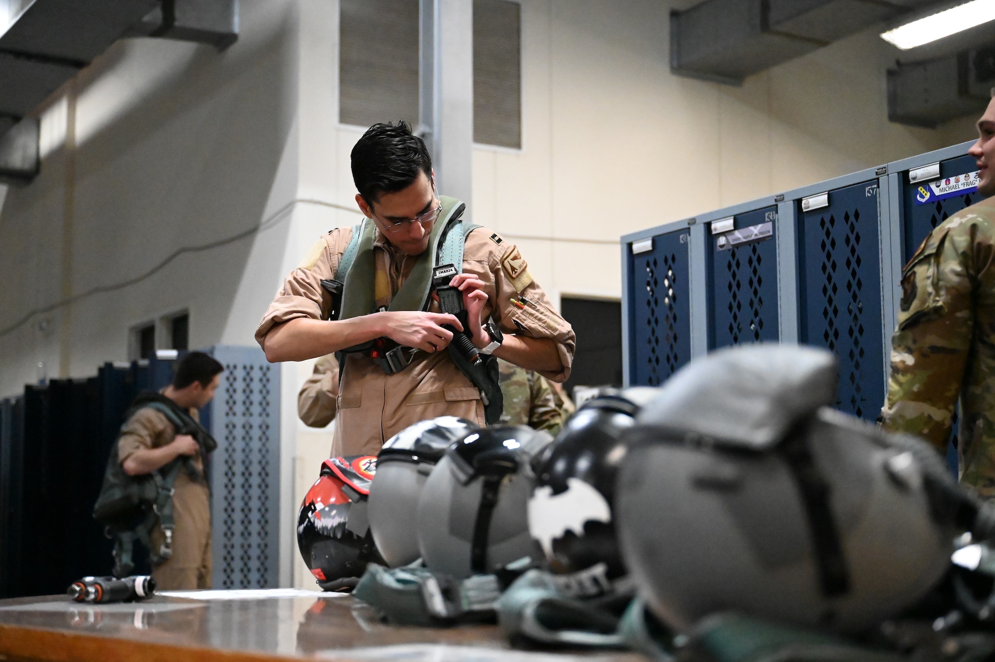 An aircrew member from the 28th Operations Group, Ellsworth Air Force Base, South Dakota, puts on flight equipment at the Aircrew Flight Equipment shop at Dyess Air Force Base, Texas, Feb. 1, 2024. Ellsworth Air Force Base B-1Bs recently launched from Dyess Air Force Base to support U.S. Central Command priorities, validating the United States Air Force capability to provide precision, long-range strike anytime, anywhere. (U.S. Air Force photo by Staff Sgt. Holly Cook)