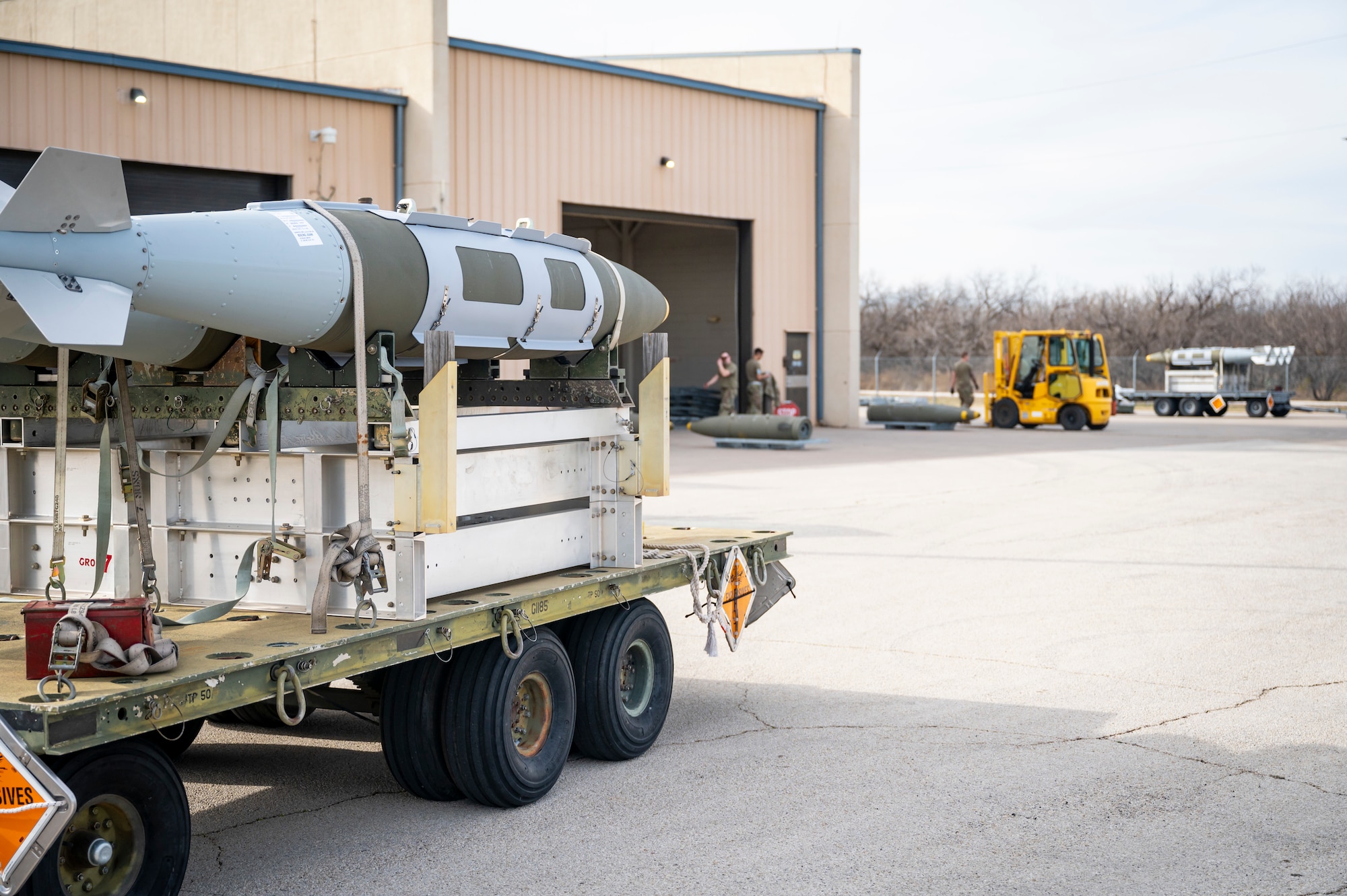 Joint Direct Attack Munitions are harnessed on a trailer before being transported on the flightline at Dyess Air Force Base, Texas, Jan. 31, 2024. Ellsworth Air Force Base B-1Bs recently launched from Dyess Air Force Base to support U.S. Central Command priorities, validating the United States Air Force capability to provide precision, long-range strike anytime, anywhere. (U.S. Air Force photo by Senior Airman Leon Redfern)