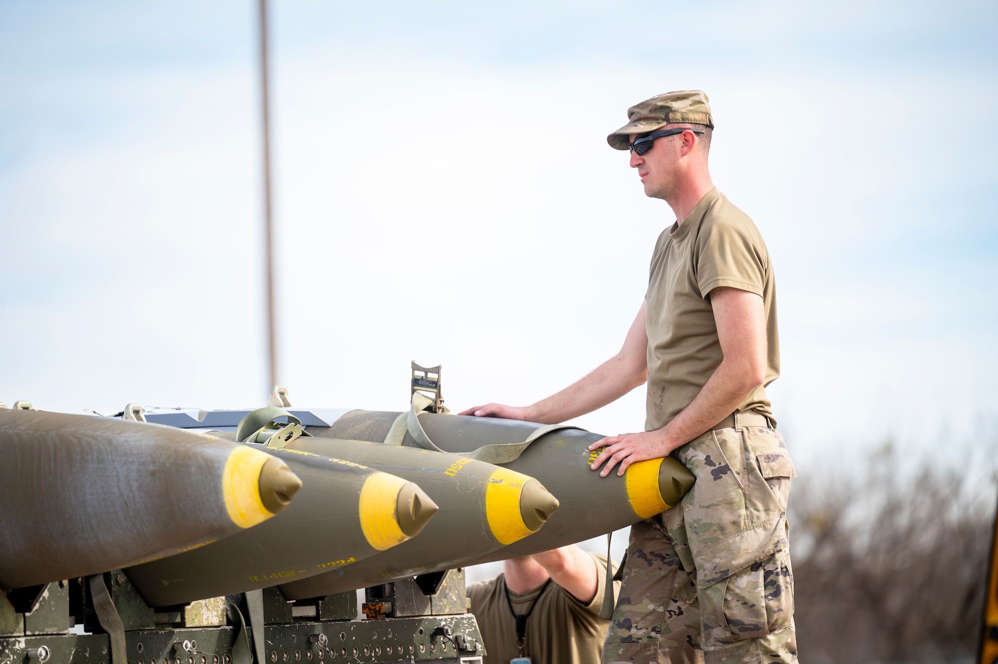 U.S. Air Force Airman, 7th Munitions Conventional Maintenance stockpile supervisor, harnesses down a Joint Direct Attack Munition for transport at Dyess Air Force Base, Texas, Jan. 31, 2024. Ellsworth Air Force Base B-1Bs recently launched from Dyess Air Force Base to support U.S. Central Command priorities, validating the United States Air Force capability to provide precision, long-range strike anytime, anywhere. (U.S. Air Force photo by Senior Airman Leon Redfern)