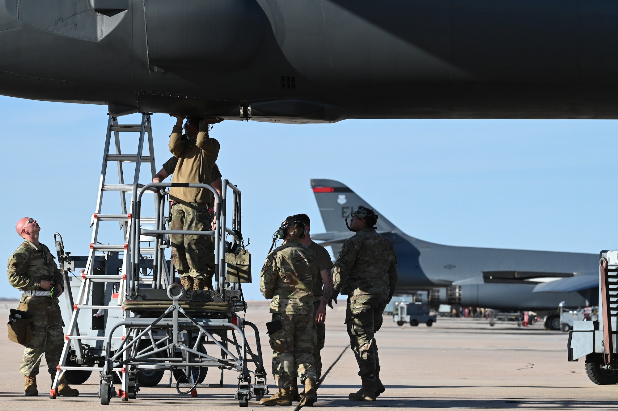 Airmen from the 28th Maintenance Group, Ellsworth Air Force Base, South Dakota, and the 7th MXG perform preflight maintenance on a B-1B Lancer on the flightline at Dyess AFB, Texas, Feb. 1, 2024. Ellsworth Air Force Base B-1Bs recently launched from Dyess Air Force Base to support U.S. Central Command priorities, validating the United States Air Force capability to provide precision, long-range strike anytime, anywhere. (U.S. Air Force photo by Staff Sgt. Holly Cook)