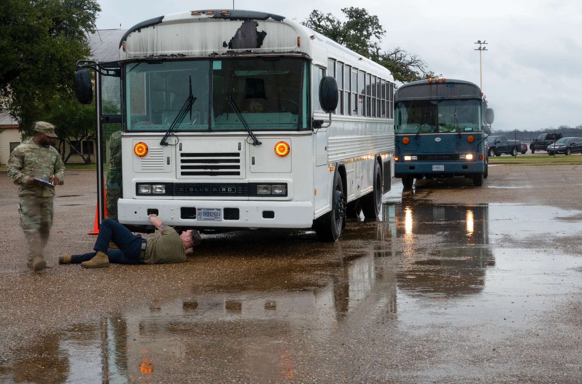 USAF Airmen examine a vehicle during a training exercise.