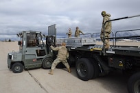 Members load missile coffins onto KLoader