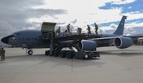 Members loading missile coffins into KC135