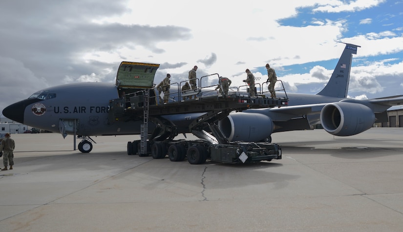 Members loading missile coffins into KC135