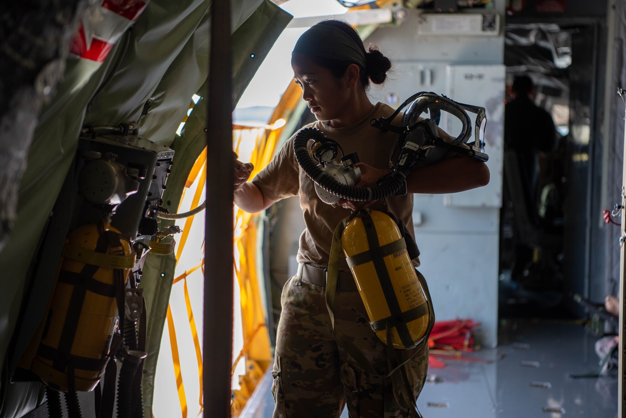 airmen holds oxygen tank