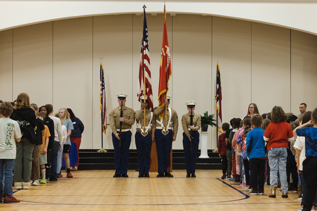 U.S. Marines assigned to Wounded Warrior Battalion-East (WWBn-E), parade the colors during the Adopt-a-School ceremony on Feb. 5, 2024 at Clear View Elementary School, in Jacksonville, North Carolina. The Adopt-a-School program gives a military unit the ability to support local schools by assisting with field trips, family nights, Month of the Military Child and other special events. (U.S. Marine Corps photo by Cpl. Jennifer E. Douds)
