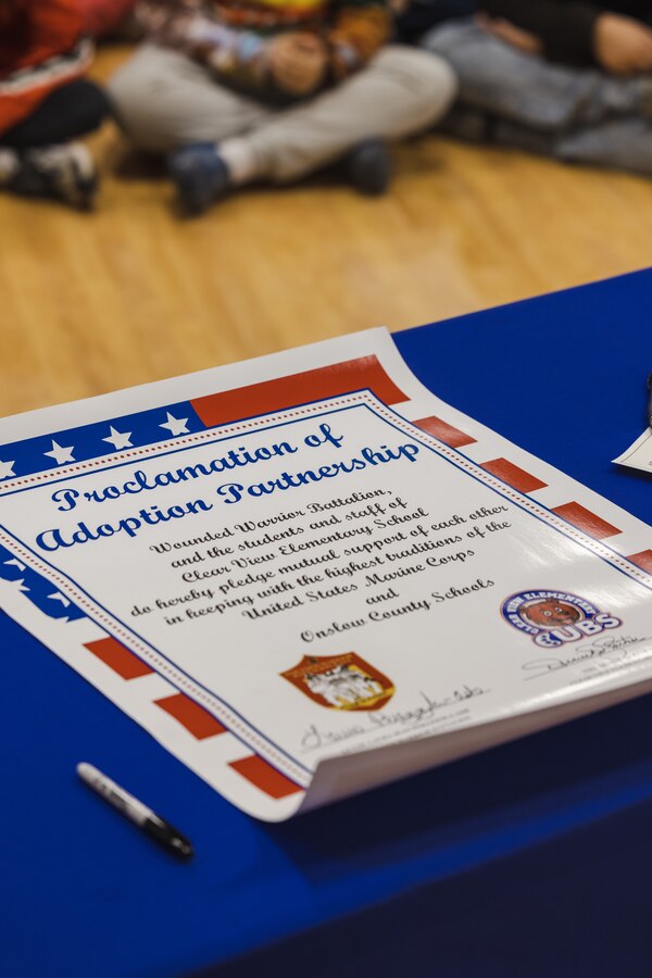 The proclamation of adoption partnership sits on a table during an Adopt-a-School ceremony on Feb. 5, 2024 at Clear View Elementary School in Jacksonville, North Carolina.  The Adopt-a-School program gives a military unit the ability to support local schools by assisting with field trips, family nights, Month of the Military Child and other special events. (U.S. Marine Corps photo by Cpl. Jennifer E. Douds)