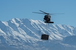 Utah Army and Air National Guardsmen particpate in a joint Exercise involving a mobile kitchen being connected to a UH-60 Black Hawk on Jan. 31, 2024, at Camp Williams. Exercise Perses challenged the tactics, techniques and procedures of both Utah Air and Army National Guard units while testing innovative ideas and communication practices.