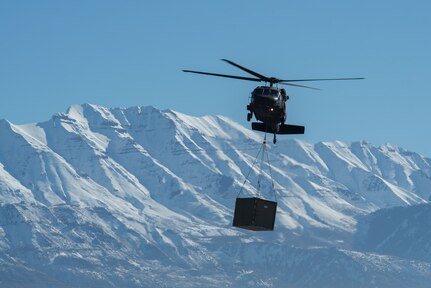 Utah Army and Air National Guardsmen particpate in a joint Exercise involving a mobile kitchen being connected to a UH-60 Black Hawk on Jan. 31, 2024, at Camp Williams. Exercise Perses challenged the tactics, techniques and procedures of both Utah Air and Army National Guard units while testing innovative ideas and communication practices.