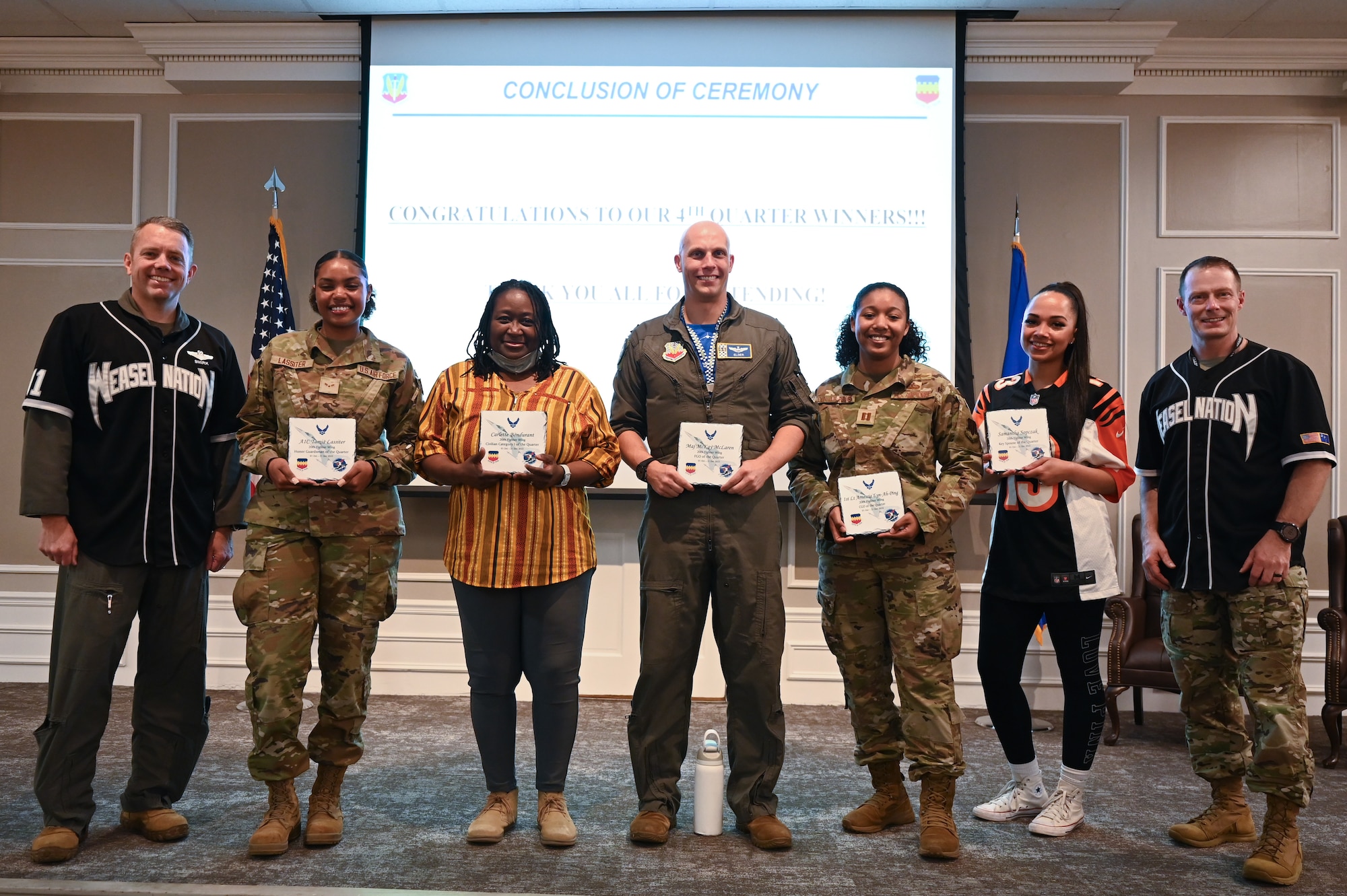 Five of the quarter award winners and two of the 20th Fighter Wing Leadership pose for a group photo.