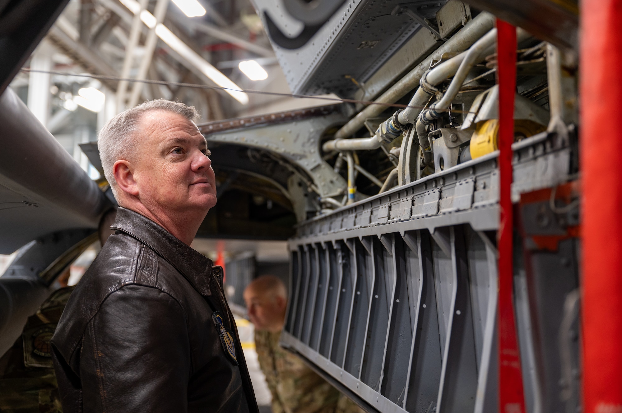 A man visually inspects the inside of a KC-135R Stratotanker wing.