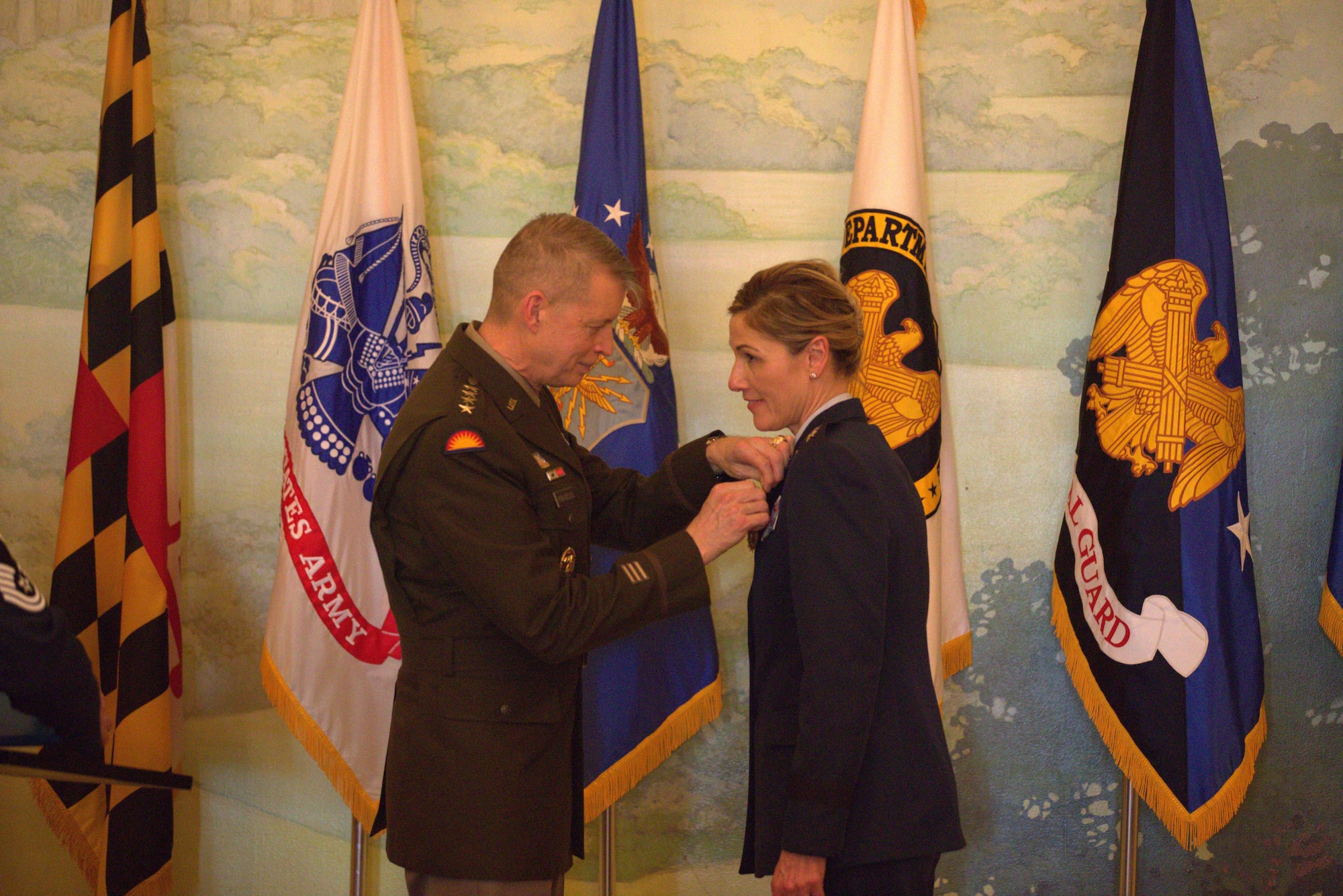U.S. Army Gen. Daniel R. Hokanson presents a retirement certificate to U.S. Air Force Maj. Gen. April D. Vogel at her retirement ceremony, January 26, 2024 at the Fife and Drum Dining Room at the Patton Hall Community Club and Conference Center, Joint Base Myer-Henderson Hall, Va. Vogel was the first female from the Maryland Air National Guard to be promoted to Major General. (U.S. Army National Guard photo by 1st Lt. Javier Cox)