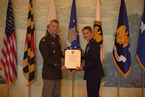 U.S. Army Gen. Daniel R. Hokanson presents a retirement certificate to U.S. Air Force Maj. Gen. April D. Vogel at her retirement ceremony, January 26, 2024 at the Fife and Drum Dining Room at the Patton Hall Community Club and Conference Center, Joint Base Myer-Henderson Hall, Va. Vogel was the first female from the Maryland Air National Guard to be promoted to Major General. (U.S. Army National Guard photo by 1st Lt. Javier Cox)
