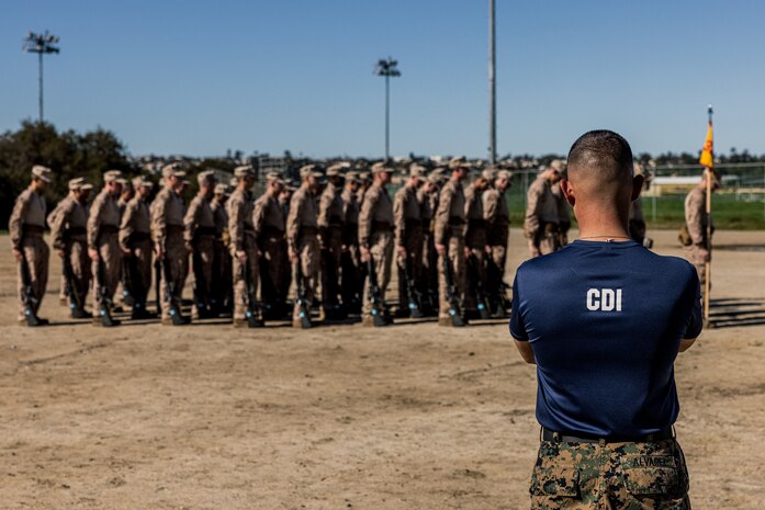 A U.S. Marine Corps chief drill instructor with Mike Company, 3rd Recruit Training Battalion, observes recruits after a Marine Corps Martial Arts Program training event at Marine Corps Recruit Depot San Diego, Jan. 29, 2024. MCMAP aims to strengthen the mental and moral resiliency of individual recruits and Marines through realistic combative training, warrior ethos studies and, physical hardening. (U.S. Marine Corps photo by Lance Cpl. Jacob B. Hutchinson)