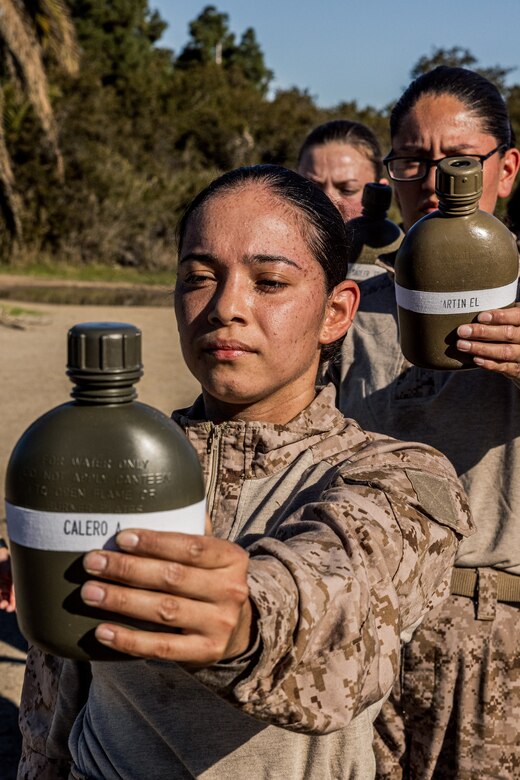 U.S. Marine Corps Recruit Aidee Calero with Mike Company, 3rd Recruit Training Battalion, holds her water source during a Marine Corps Martial Arts Program training event at Marine Corps Recruit Depot San Diego, Jan. 29, 2024. MCMAP aims to strengthen the mental and moral resiliency of individual recruits and Marines through realistic combative training, warrior ethos studies, and physical hardening. Calero is a native of San Diego. (U.S. Marine Corps photo by Lance Cpl. Jacob B. Hutchinson)