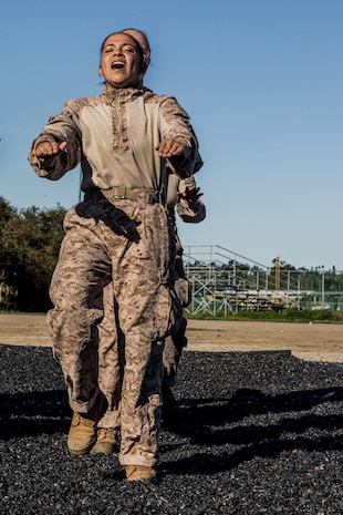 U.S. Marine Corps Recruit Aidee Calero with Mike Company, 3rd Recruit Training Battalion, executes dynamic warm-up exercises before a Marine Corps Martial Arts Program training event at Marine Corps Recruit Depot San Diego, Jan. 29, 2024. MCMAP aims to strengthen the mental and moral resiliency of individual recruits and Marines through realistic combative training, warrior ethos studies, and physical hardening. Calero is a native of San Diego. (U.S. Marine Corps photo by Lance Cpl. Jacob B. Hutchinson)