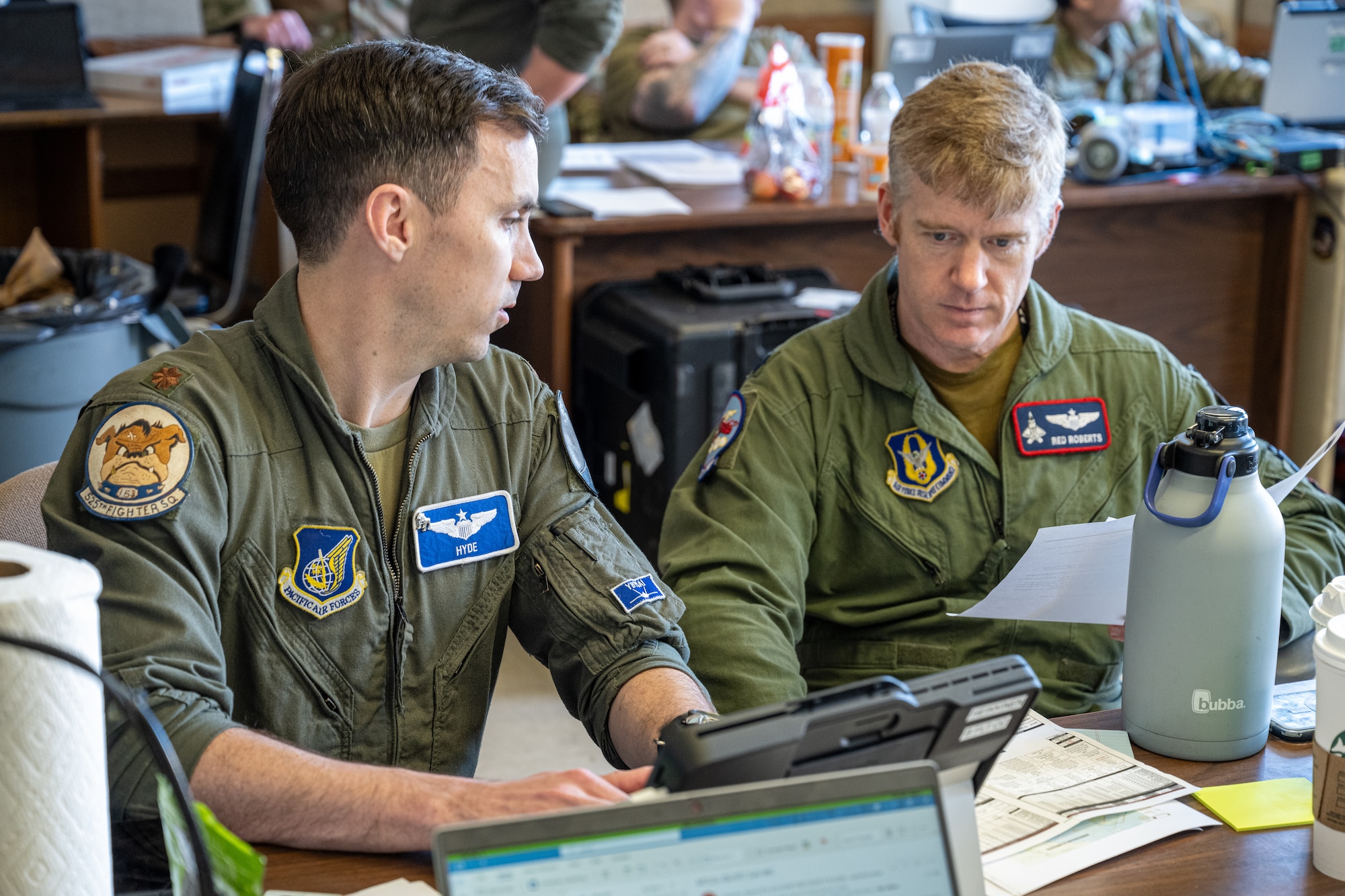 F-22 Raptor pilots assigned to the 525th Expeditionary Fighter Squadron, 3rd Air Expeditionary Wing, out of Joint Base Elmendorf-Richardson, Alaska, mission plan in the tactical operations center during Exercise Bamboo Eagle 24-1 at spoke Naval Air Station North Island, California, Jan. 31, 2024.
