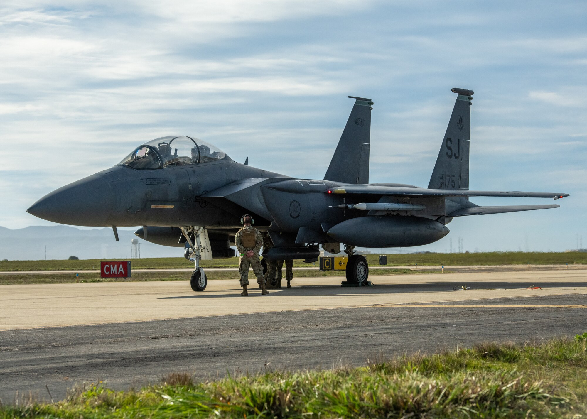 An Airman stands near an F-15E.