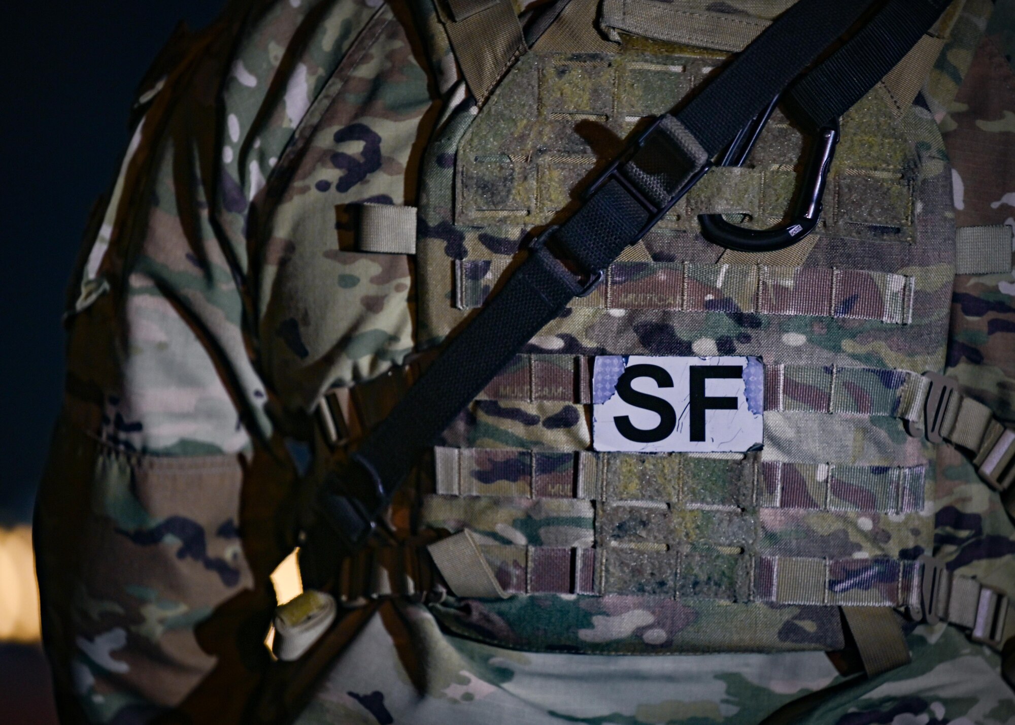 A security forces patch is worn on an Airman's armor.