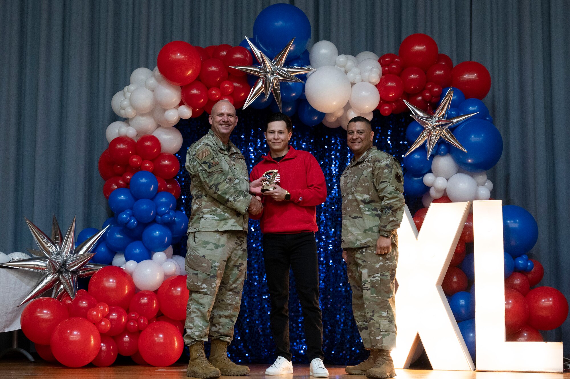 U.S. Air Force Col. Kevin Davidson, 47th Flying Training Wing (FTW) commander, and Chief Master Sgt. Lester Largaespada, 47th FTW command chief, present Jose Cervera, 47th Mission Support Group, an award during the 2023 47th FTW Annual Awards Ceremony at Laughlin Air Force Base, Texas, Feb. 2, 2024. Annual award winners were selected based on their technical expertise, demonstration of leadership and job performance. (U.S. Air Force photo by Senior Airman Kailee Reynolds)
