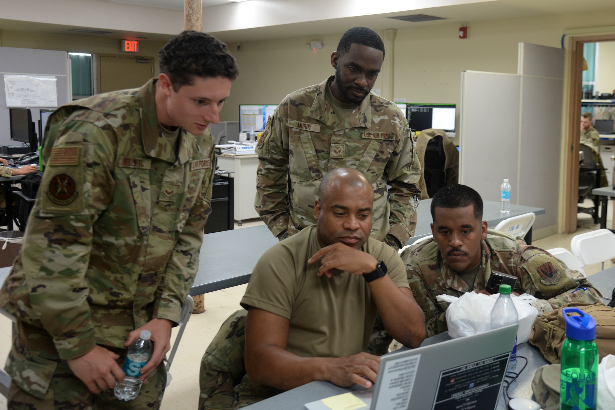 Airmen from the 175th Communications Squadron work together on a laptop at Muniz Air National Guard Base, Puerto Rico on July 24, 2023. The work was completed as part of an annual training for the 175th Communications Squadron.